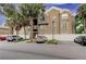 Tan colored building exterior with palm trees and parking at 15215 Amberly Dr # 206, Tampa, FL 33647