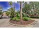 Gated community entrance with lush landscaping and brick pavers at 15215 Amberly Dr # 206, Tampa, FL 33647