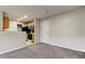 Spacious living room with grey carpet and access to the kitchen at 15215 Amberly Dr # 206, Tampa, FL 33647