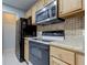 Updated kitchen featuring stainless steel appliances and wood cabinets at 15215 Amberly Dr # 206, Tampa, FL 33647