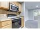 Eat-in kitchen with stainless steel appliances and wood cabinets at 15215 Amberly Dr # 206, Tampa, FL 33647
