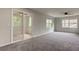 Spacious bedroom with grey carpet and access to a balcony at 15215 Amberly Dr # 206, Tampa, FL 33647