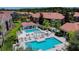 Community pool area with lounge chairs and a pergola at 15215 Amberly Dr # 206, Tampa, FL 33647
