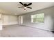 Bright living room featuring a ceiling fan and sliding glass door at 15215 Amberly Dr # 206, Tampa, FL 33647