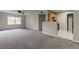 Spacious living room with gray carpeting and a ceiling fan at 15215 Amberly Dr # 206, Tampa, FL 33647