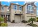 Modern two-story townhome with attached garage and landscaping at 31556 Woodland Race Loop, Wesley Chapel, FL 33545
