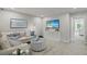 Bright bonus room features a comfortable seating area and large TV at 31556 Woodland Race Loop, Wesley Chapel, FL 33545