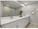 Double vanity bathroom with a large mirror and shower at 31556 Woodland Race Loop, Wesley Chapel, FL 33545