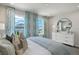 Bright bedroom with a comfy bed, dresser, and large windows offering a nice view at 31556 Woodland Race Loop, Wesley Chapel, FL 33545
