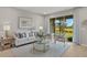 Living room with a beige couch, chairs and a view into the kitchen and dining area at 31556 Woodland Race Loop, Wesley Chapel, FL 33545
