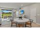 Light and airy dining area with round table and chairs, looking toward the living room and sliding glass doors at 31556 Woodland Race Loop, Wesley Chapel, FL 33545