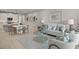 Open concept living room with light-colored furniture and view into the kitchen and dining area at 31556 Woodland Race Loop, Wesley Chapel, FL 33545