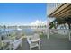 Relaxing deck overlooking the water with white chairs at 2505 Bay Blvd # 1, Indian Rocks Beach, FL 33785