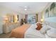 Main bedroom with king bed and sliding doors to balcony at 2505 Bay Blvd # 1, Indian Rocks Beach, FL 33785