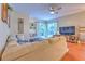 Spacious living room with hardwood floors, sectional sofa, and a large TV at 4923 Willow Ridge Ter, Valrico, FL 33596