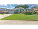 Charming one-story house with a gray roof, well-maintained lawn, and a driveway at 4923 Willow Ridge Ter, Valrico, FL 33596