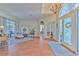 Living room with hardwood floors, featuring a comfortable sectional sofa and large windows at 4923 Willow Ridge Ter, Valrico, FL 33596