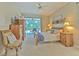 Main bedroom with king bed, access to backyard, and dresser at 4923 Willow Ridge Ter, Valrico, FL 33596