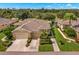 Attractive villa with 2 car garage, lush landscaping, and golf course views at 1916 Inverness Greens Dr, Sun City Center, FL 33573