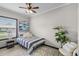 Bright bedroom with a striped bedspread and plenty of natural light at 402 E Emma St, Tampa, FL 33603