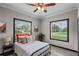 Cozy bedroom with a comfortable bed, large windows, and stylish decor at 402 E Emma St, Tampa, FL 33603