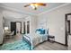Bedroom with teal rug and en-suite bathroom at 402 E Emma St, Tampa, FL 33603