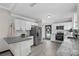 Modern kitchen with white cabinets, granite countertops, and stainless steel appliances at 402 E Emma St, Tampa, FL 33603
