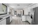 Open concept kitchen with island and view into the living area at 402 E Emma St, Tampa, FL 33603