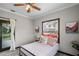 Bedroom with a bed, window, and access to a private porch at 402 E Emma St, Tampa, FL 33603