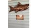 Metal fish art and a humorous sign add character to the porch at 525 San Jose Dr, Dunedin, FL 34698