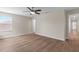 Inviting bedroom with wood flooring, a ceiling fan, and a window offering lots of natural light at 3147 Calvano Dr, Land O Lakes, FL 34639