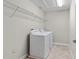 Functional laundry room equipped with washer, dryer, and convenient wire shelving at 3147 Calvano Dr, Land O Lakes, FL 34639