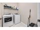 Laundry room with washer, dryer, and additional shelving at 20983 Fetterbush Pl, Venice, FL 34293