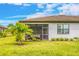 Home exterior showcasing screened lanai and landscaping at 20983 Fetterbush Pl, Venice, FL 34293