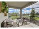 Relaxing screened patio with outdoor furniture and a view of a pond at 31552 Woodland Race Loop, Wesley Chapel, FL 33545