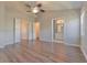 Bright bedroom with wood floors, ceiling fan, and access to bathroom and closet at 2935 Bayshore Pointe Dr, Tampa, FL 33611