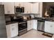 Kitchen with stainless steel appliances and white cabinets at 14117 Weddington Ter, Hudson, FL 34669