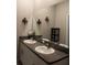 Double vanity bathroom with granite countertop and large mirror at 14117 Weddington Ter, Hudson, FL 34669