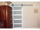 White barn door with frosted glass panels at 14117 Weddington Ter, Hudson, FL 34669