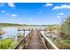 Wooden dock extending over calm lake water at 2295 Americus E Blvd # 27, Clearwater, FL 33763