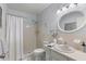 Clean bathroom with shower/tub combo, vanity, and oval mirror at 2295 Americus E Blvd # 27, Clearwater, FL 33763