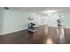 Spacious living room with dark hardwood floors and a view into the kitchen at 2295 Americus E Blvd # 27, Clearwater, FL 33763