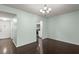 Bright dining room with dark hardwood floors and view into kitchen at 2295 Americus E Blvd # 27, Clearwater, FL 33763