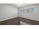 Bright bedroom with dark hardwood floors and large window at 2295 Americus E Blvd # 27, Clearwater, FL 33763