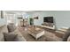 Living room with ample seating, a coffee table, and a large TV at 2295 Americus E Blvd # 27, Clearwater, FL 33763