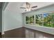 Bright bedroom with large windows, hardwood floors, and ceiling fan at 2295 Americus E Blvd # 27, Clearwater, FL 33763