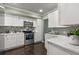 Modern kitchen with white cabinets, stainless steel appliances, and quartz countertops at 2295 Americus E Blvd # 27, Clearwater, FL 33763