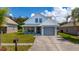 Charming two-story home with a gray garage, well-kept lawn and landscaping under blue skies at 10209 Summerview Cir, Riverview, FL 33578