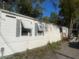 Long exterior of house with closed shutters and handicap ramp at 10542 Helena St, New Port Richey, FL 34654