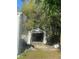 An open garage with a driveway and surrounding greenery offers ample storage and parking at 10542 Helena St, New Port Richey, FL 34654